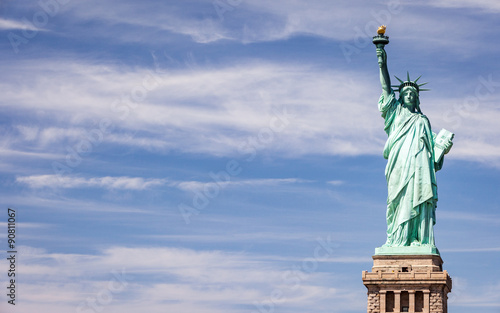 Statue of Liberty, NYC, USA. A view of the familiar New York landmark set against a bright blue spring sky with copy space.