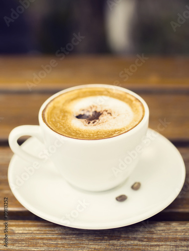 Cup of cappuccino on a wooden table