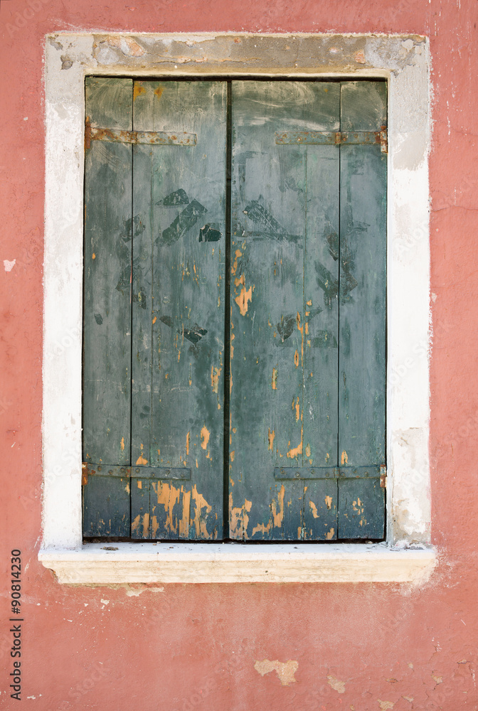 Green wooden window cover of an old house Green wooden window cover of an old house