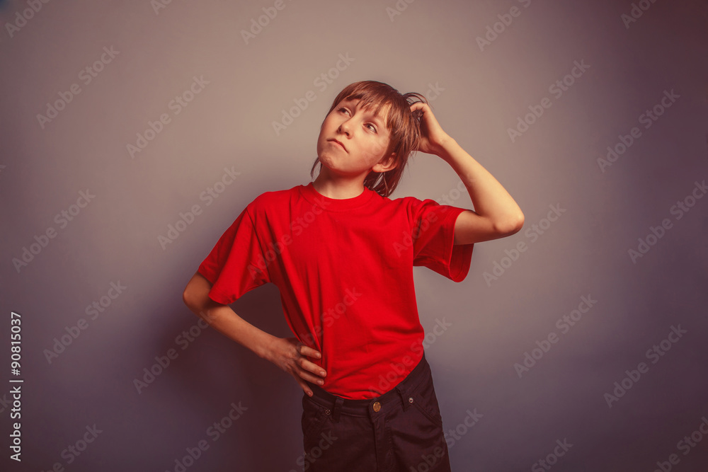 European-looking boy of ten years thinking, scratching his head European-looking boy of ten years thinking, scratching his head
