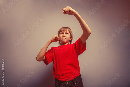 Boy, teenager, twelve years  red  in shirt,  showing his fists r © maxximmm