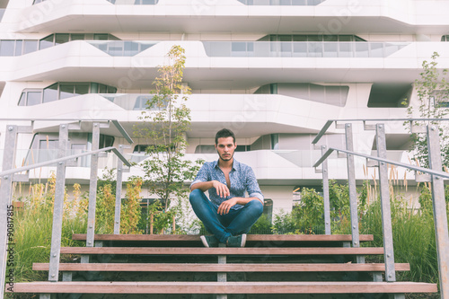 Young handsome man posing in the city streets