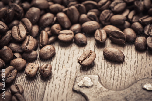 Roasted coffee beans on a rustic old wooden table