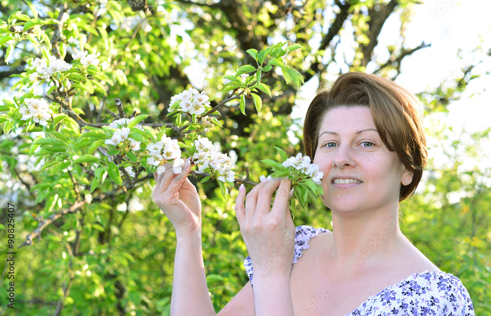 Awoman in  apple orchard at  early spring