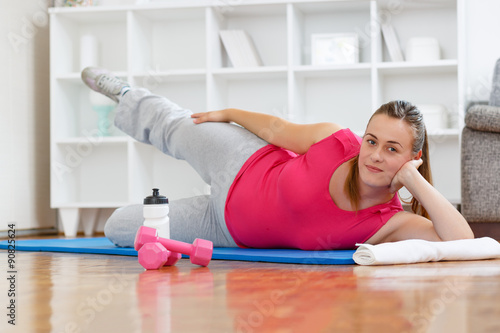 Young mother practicing to get back into shape after giving birth photo