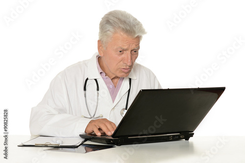 Elderly doctor with laptop