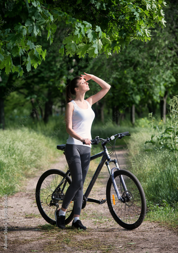 Girl on a bicycle in a forest