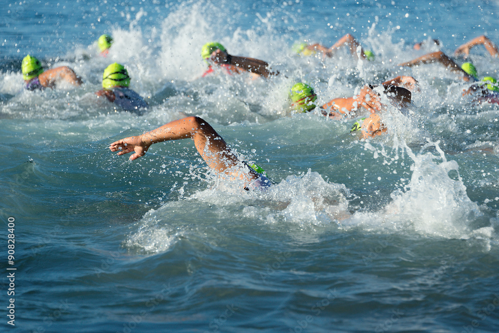 Group people in wetsuit swimming at triathlon