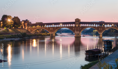 Pavia, Italy: Covered bridge over the river Ticino at sunset © ngaliero