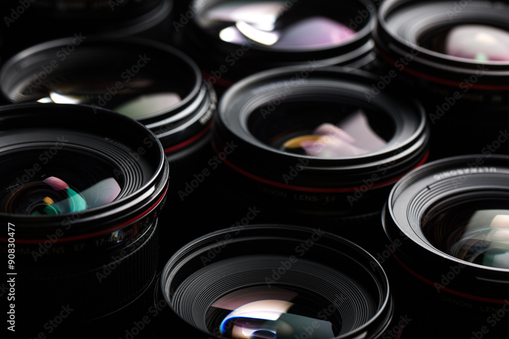 Modern camera lenses with reflections, low key image Modern camera lenses with reflections, low key image