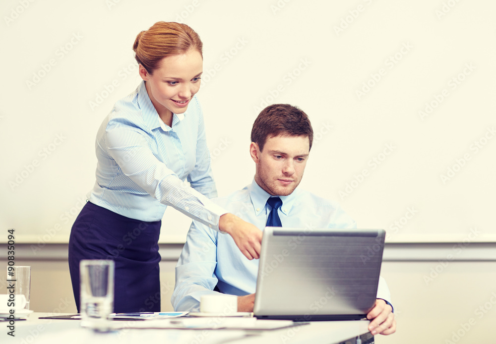 businessman and secretary with laptop in office businessman and secretary with laptop in office