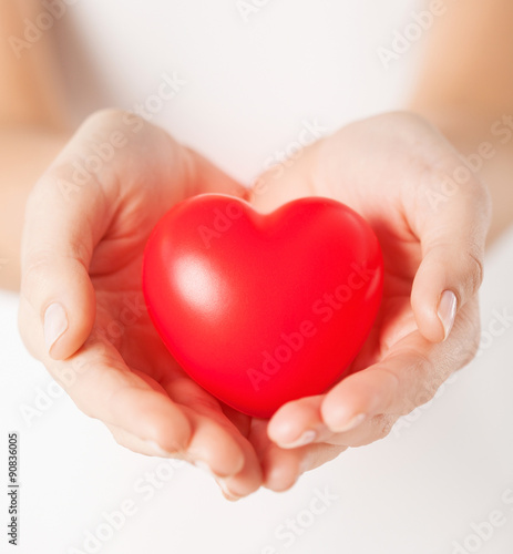 female hands with small red heart