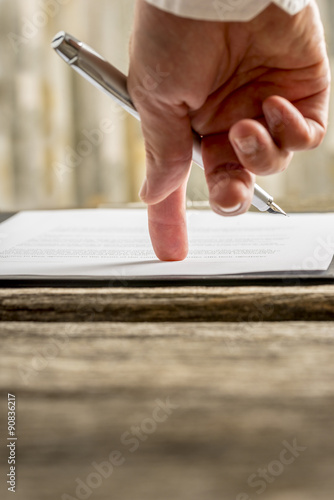 Low angle view of  businessman hand pointing with his finger whe photo