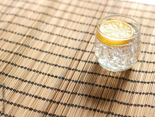 Cold lemonade with ice placed on wooden photo