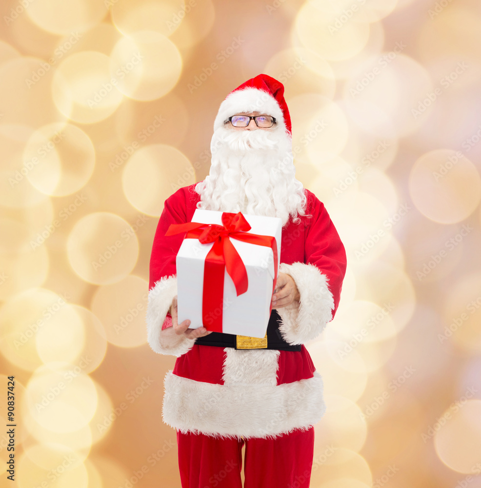 man in costume of santa claus with gift box man in costume of santa claus with gift box