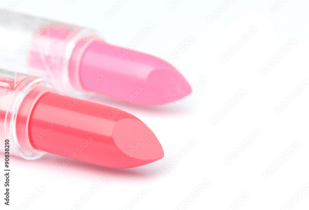 Two whole and one sliced lipsticks on white Two whole and one sliced lipsticks on white