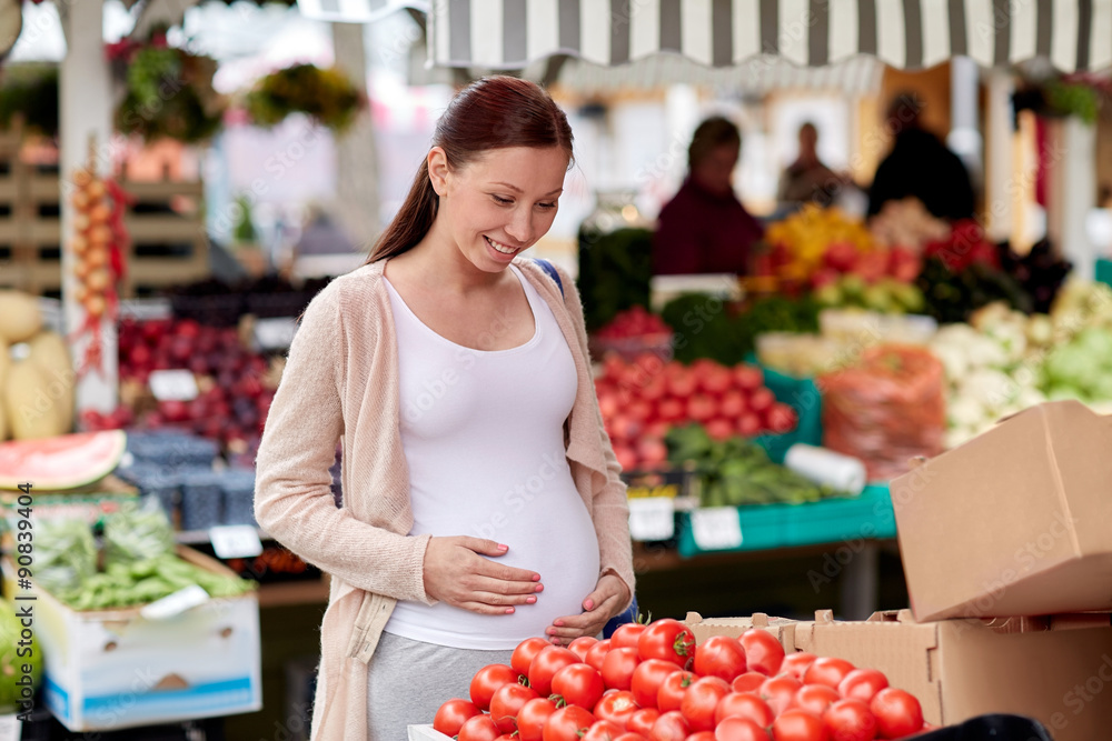 pregnant woman choosing food at street market pregnant woman choosing food at street market