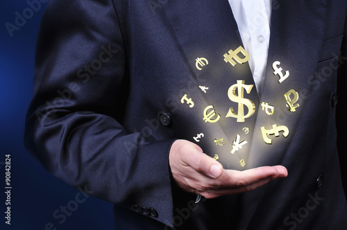 Currency gold symbols in a man hand