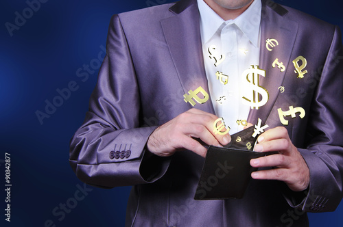 Currency gold symbols in a brown wallet