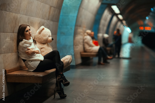 Girl is sad sitting on the bench. photo