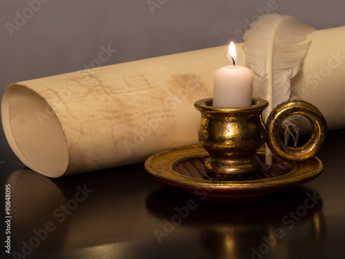 Antique Candle with a feather and parchment 