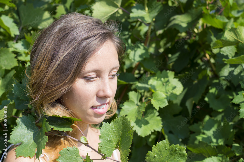 Happy girl surrounded by green leaves Happy girl surrounded by green leaves