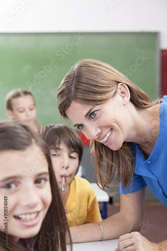 Teacher looking at pupil and smiling