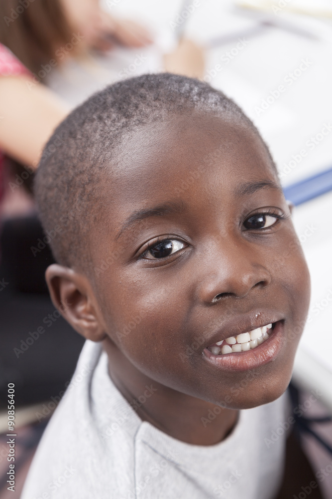 Naklejka premium Happy african boy looking at camera and smiling