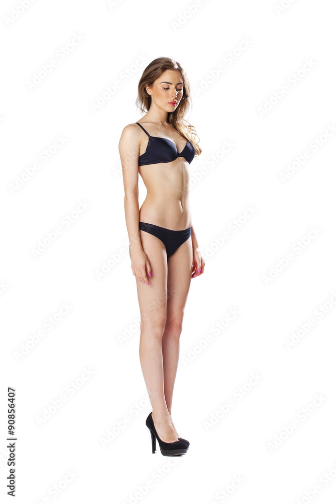 Full length portrait of a beautiful young model in black bikini