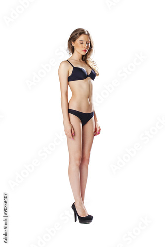 Full length portrait of a beautiful young model in black bikini