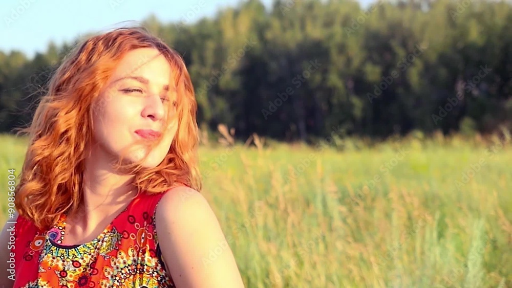 young red-haired woman with full red lips posing to photographer young red-haired woman with full red lips posing to photographer
