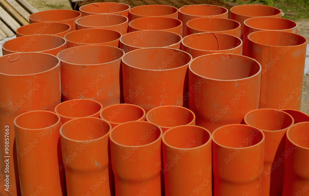 A bundle of red pvc pipes for underground pipelines sewer