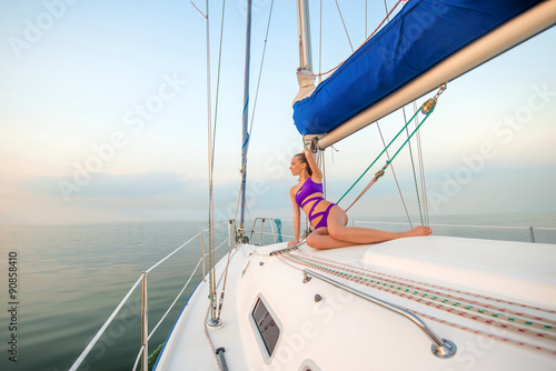 Beautiful girl sunbathing on the yacht.  © DenisProduction.com