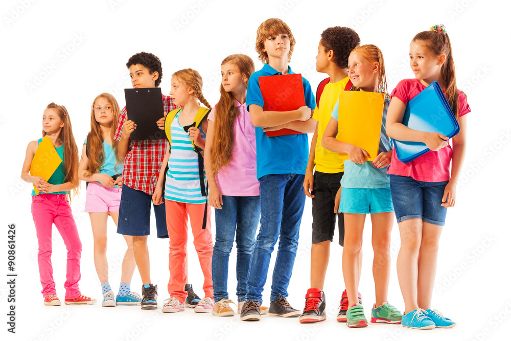 School kids standing in the line with books School kids standing in the line with books