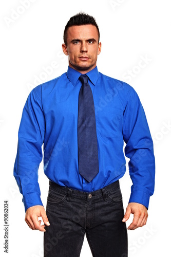 Portrait of young standing businessman in blue shirt