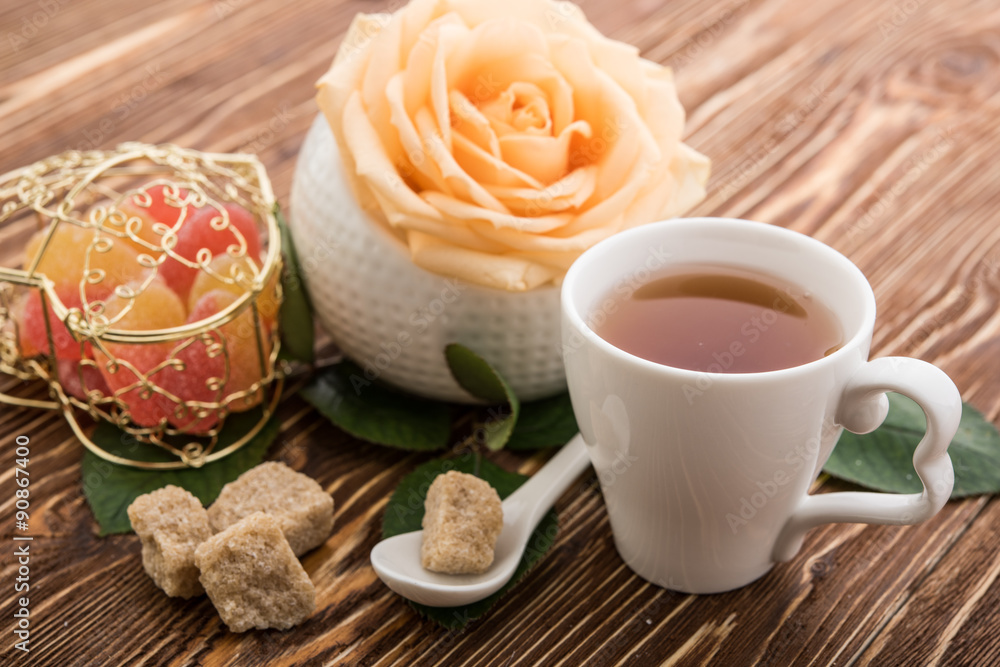 Tea cups with teapot on old wooden table