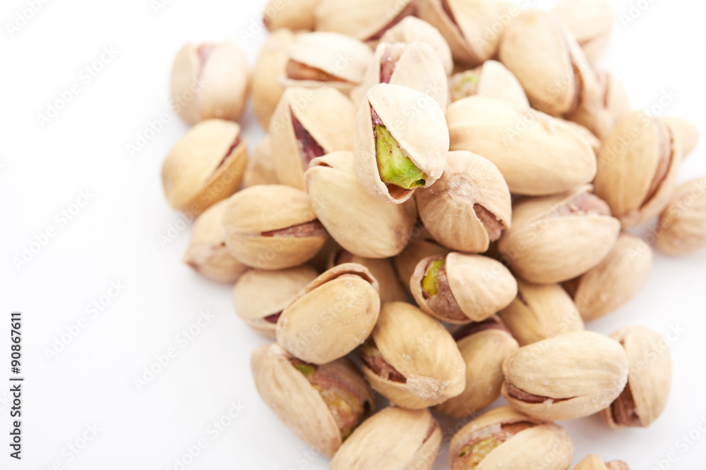 Heap of pistachios nuts isolated on the white Heap of pistachios nuts isolated on the white