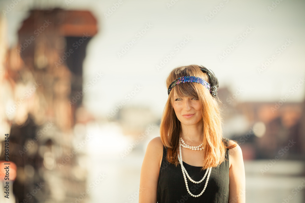 Flapper girl woman in1920s style standing on the street Flapper girl woman in1920s style standing on the street