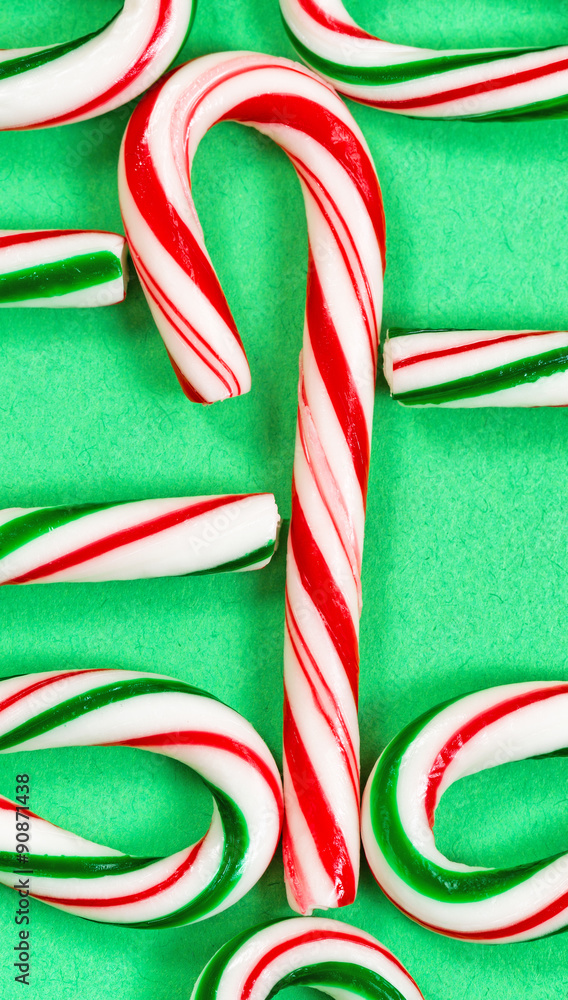 Fototapeta premium Candy canes joined in a collection on a green background