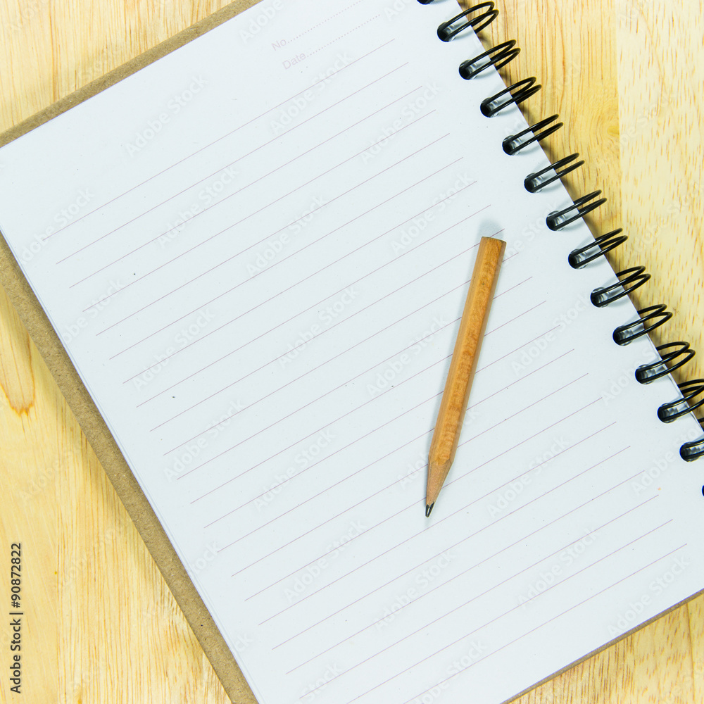 Pencil and open note book Pencil and open note book
