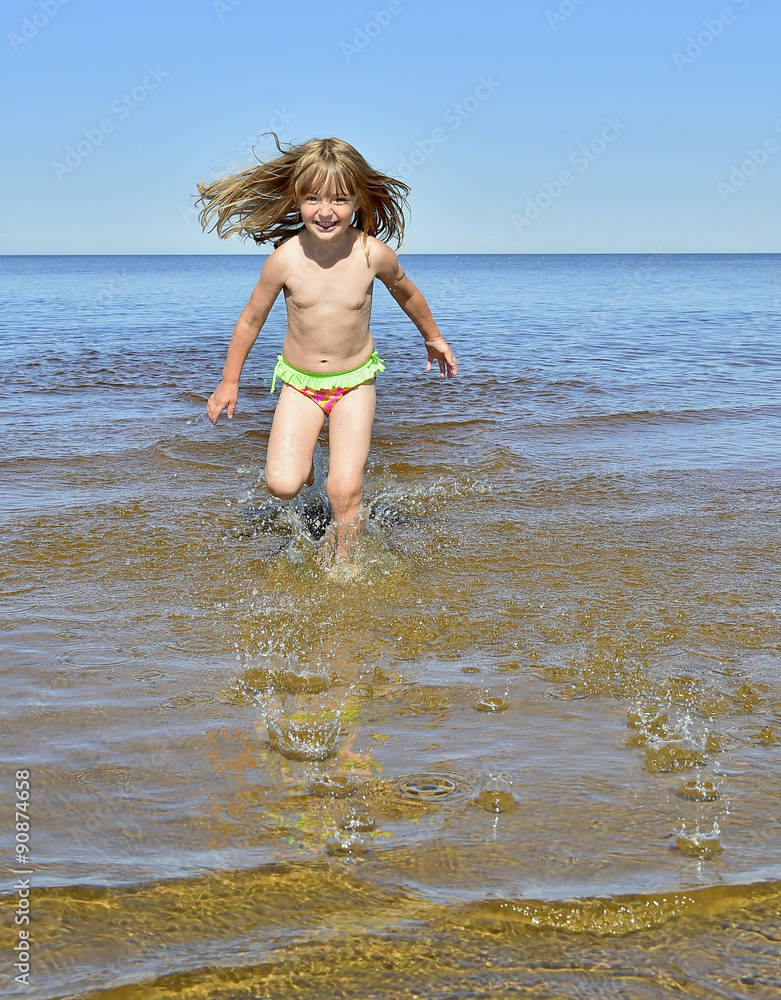 Adorable funny baby girl splashing in the water Adorable funny baby girl splashing in the water