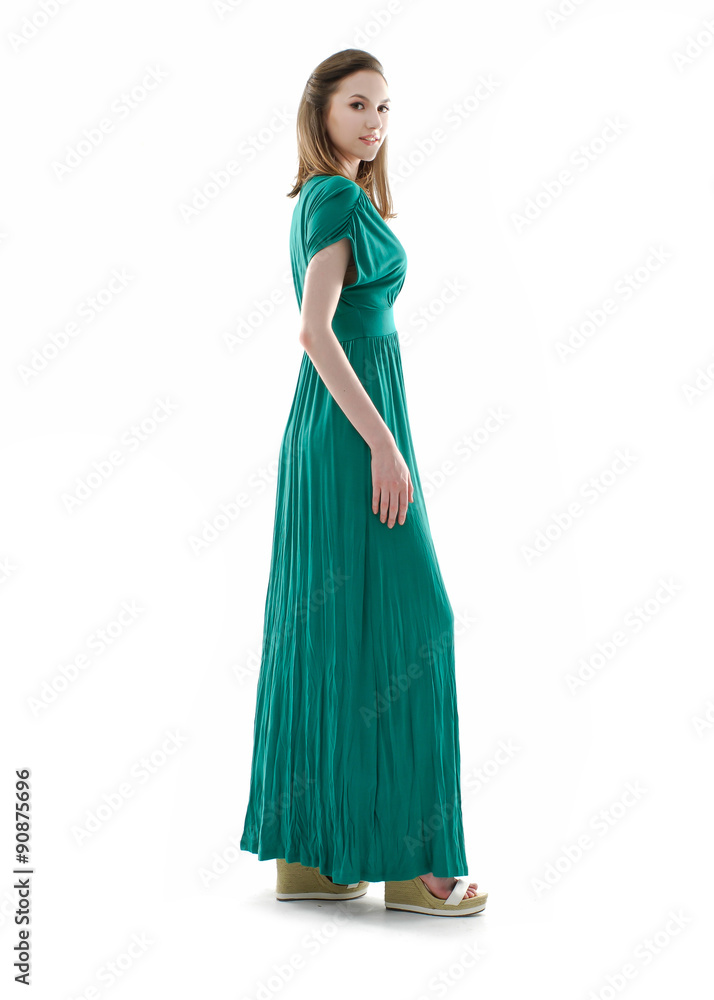 beautiful young fashion model in blue evening gown walking in studio