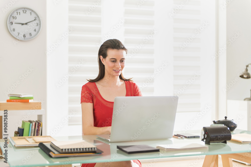 At office, modern businesswoman examining a project on a laptop At office, modern businesswoman examining a project on a laptop
