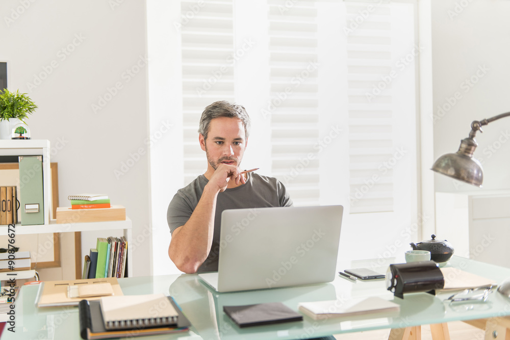 designer sitting at office working on his laptop designer sitting at office working on his laptop