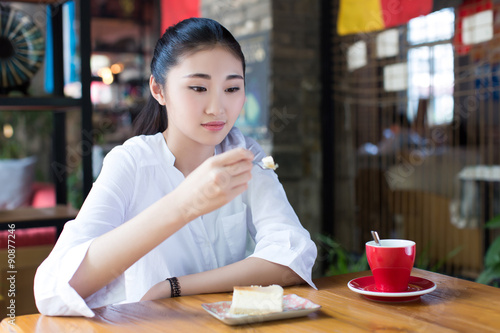 girl eating a cake in cafe