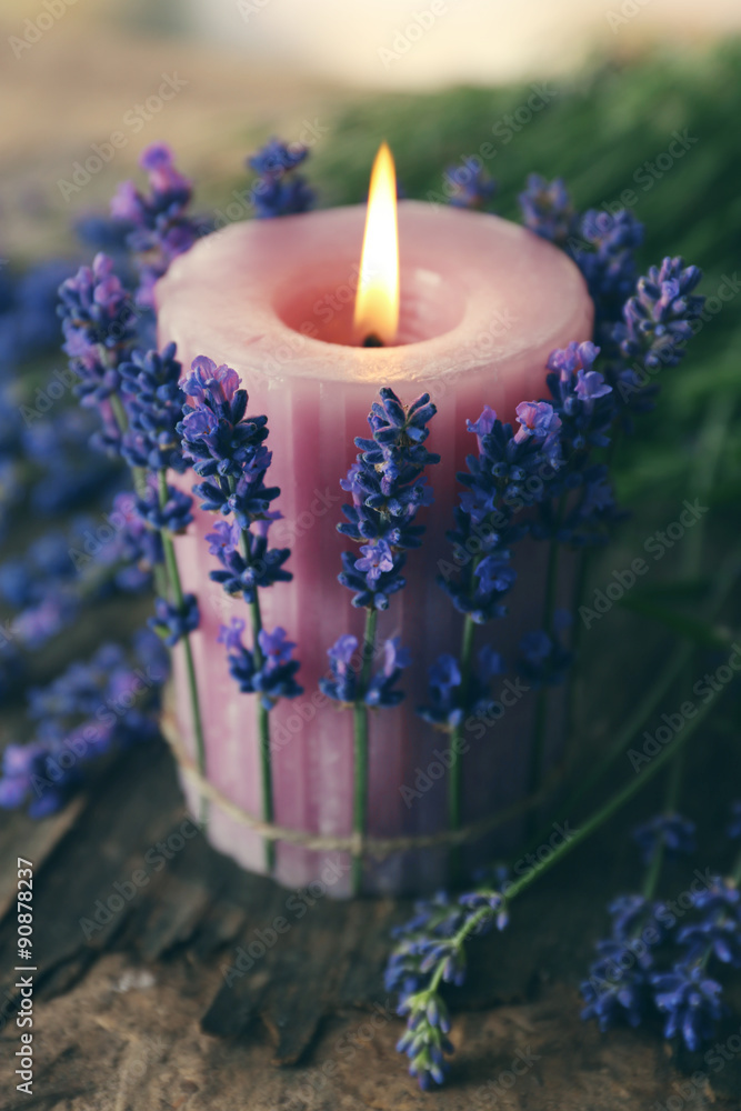 Fototapeta premium Candle with lavender flowers on table close up