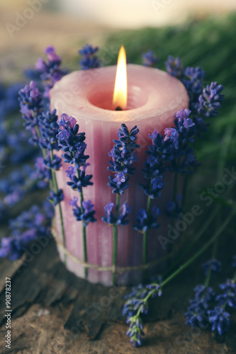 Fototapeta Naklejka Na Ścianę i Meble -  Candle with lavender flowers on table close up