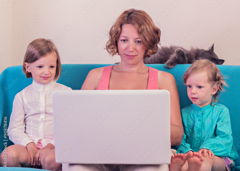 Mother with little daughters watching the laptop. Mother with little daughters watching the laptop.