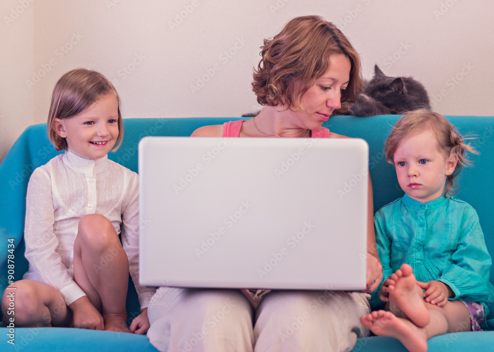 Mother with little daughters watching the laptop. Mother with little daughters watching the laptop.
