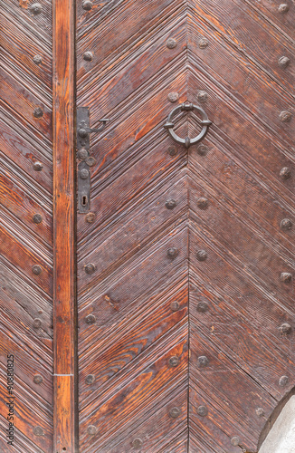 Ancient oak wood door with handle, lock and knocker